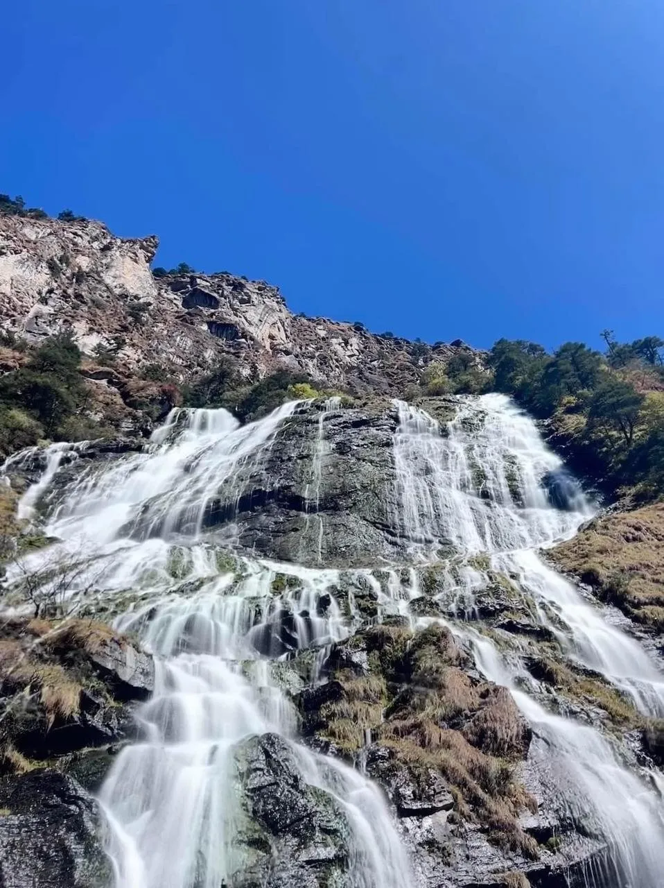 Mountain waterfall cascading over rocks near Tawang
