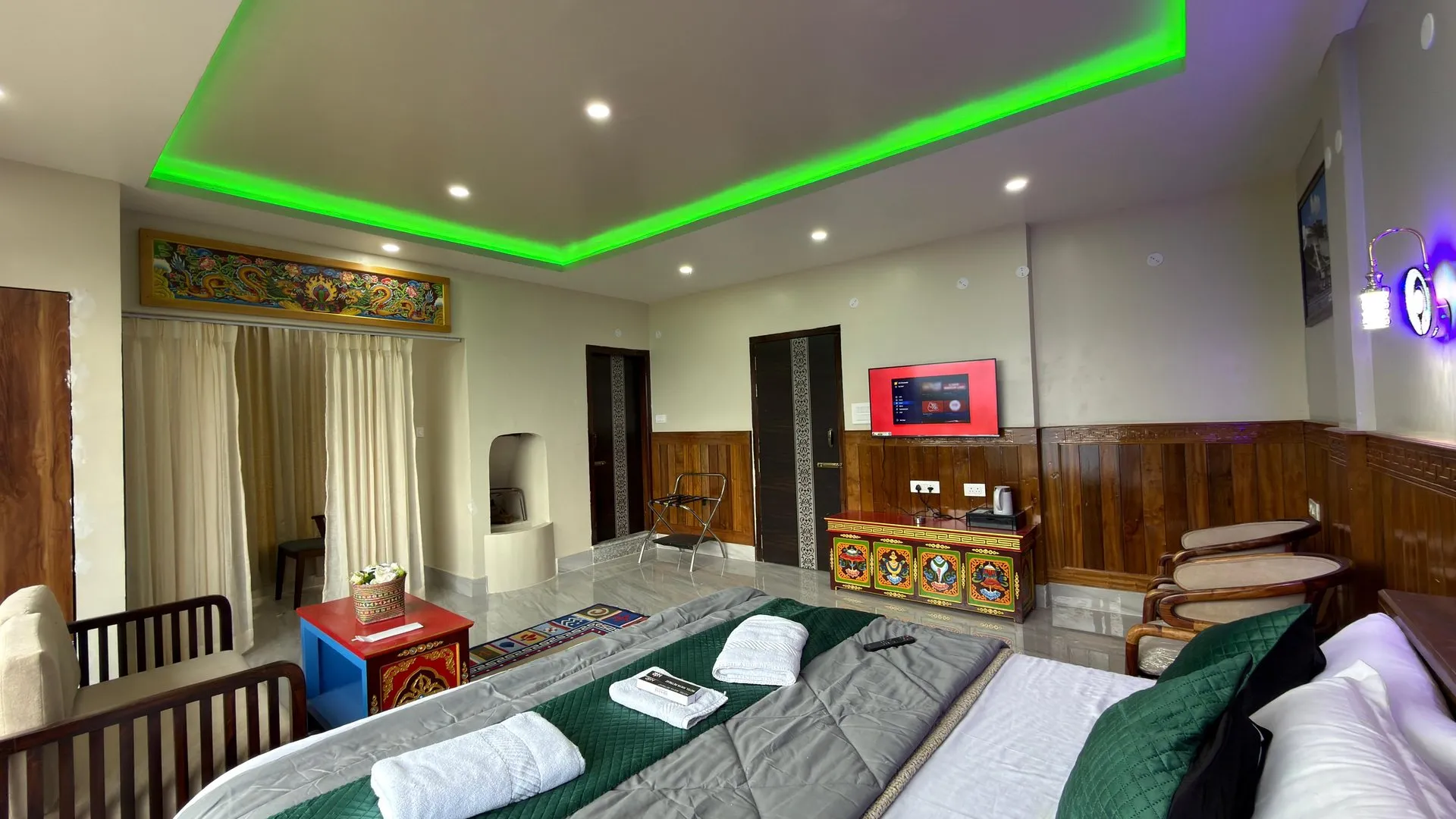 Suite Room showing the double bed, towels, seating and television