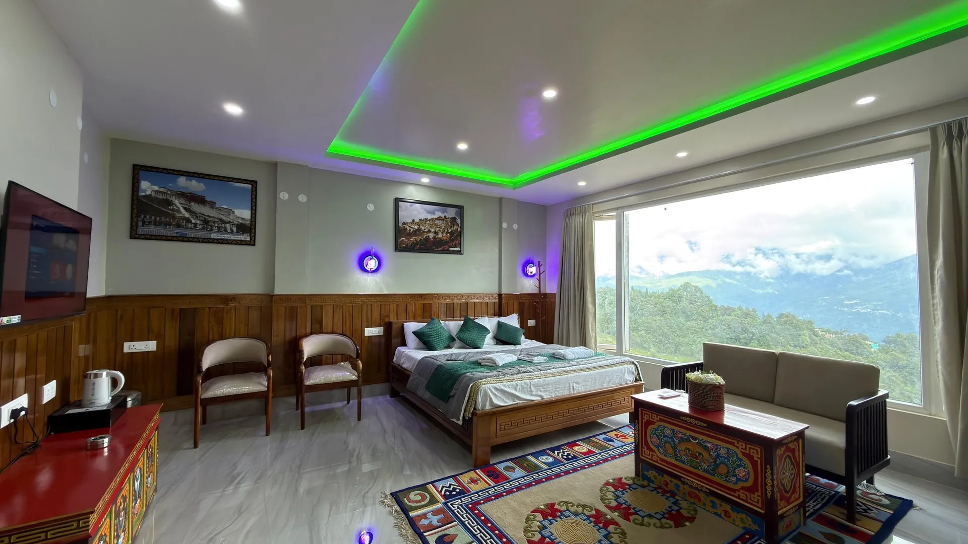 Suite Room at Rikya Retreat with a double bed, seating area and mountain view