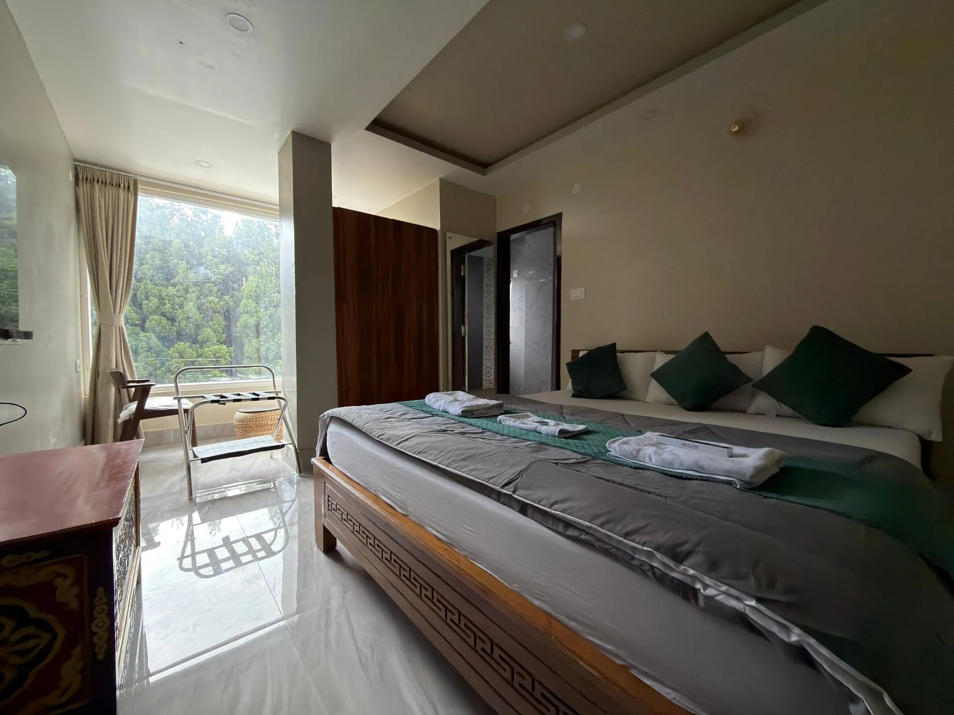 Alternate angle of the Super Deluxe Room bed and large window